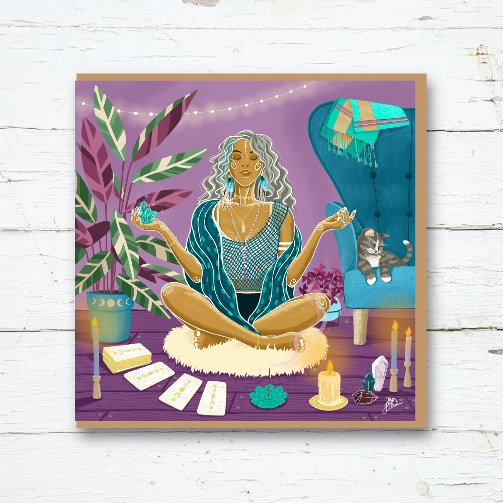woman meditating with crystals, cards and candles